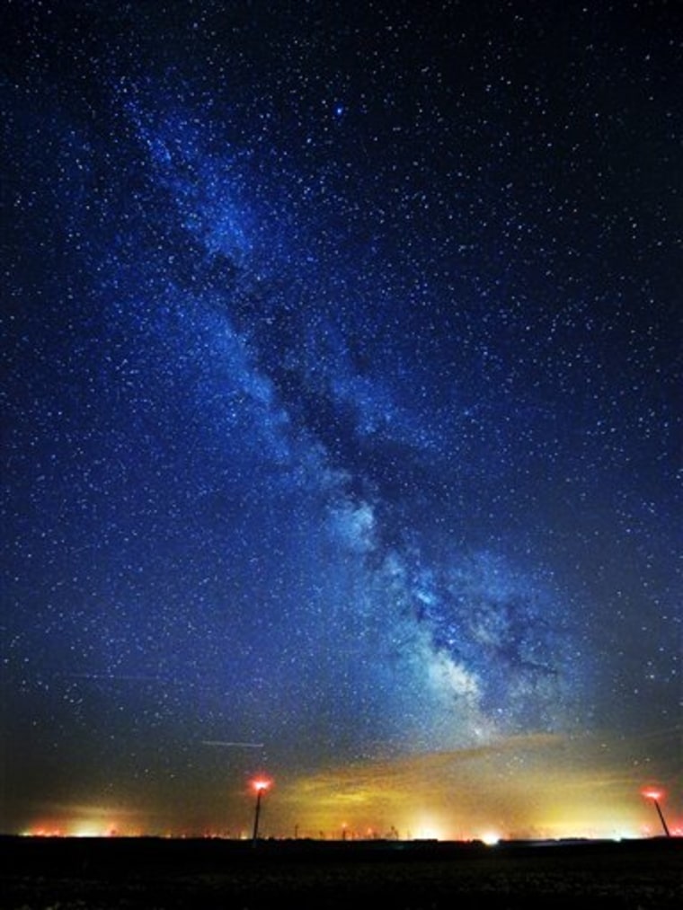 This photo shows the Milky Way above wind turbines near Lake Benton and Hendricks, Minn. Scientists have estimated the first cosmic census of planets in our galaxy and the numbers are astronomical: at least 50 billion planets in the Milky Way.